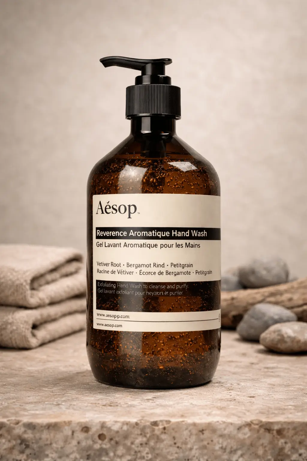 Aesop Reverence hand wash bottle shown with visible granulated liquid texture under neutral studio lighting